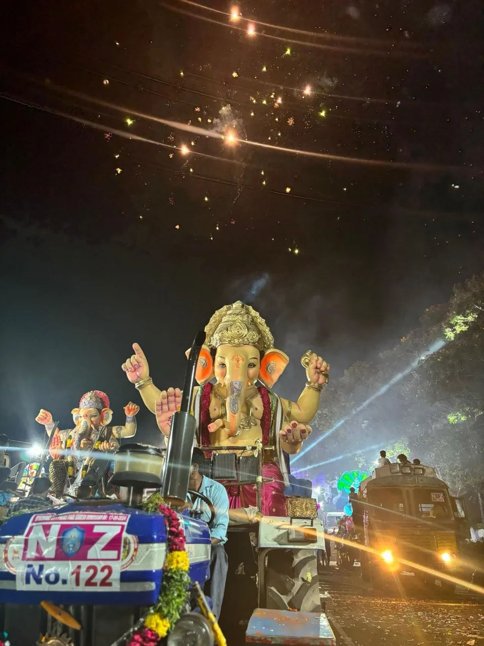 Bappa on the Visarjan procession, beams of light above